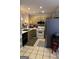 Kitchen with stainless steel appliances, wooden cabinets, and tiled floors at 116 Winthrop Dr, Sharpsburg, GA 30277