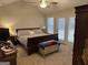 Large main bedroom with vaulted ceiling, french doors, and carpeted floors at 116 Winthrop Dr, Sharpsburg, GA 30277