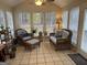 Bright sunroom with wicker furniture, plants, and tiled floor at 116 Winthrop Dr, Sharpsburg, GA 30277