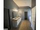 Double vanity bathroom with dark countertop and tile floor at 1529 Evergreen Hollow Ln, Conyers, GA 30012