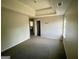 Well-lit bedroom with carpeted floor and access to hallway at 1529 Evergreen Hollow Ln, Conyers, GA 30012