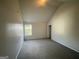 Bedroom with vaulted ceiling, carpet, and window at 1529 Evergreen Hollow Ln, Conyers, GA 30012