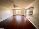 Spacious living room with hardwood floors and kitchen view at 1529 Evergreen Hollow Ln, Conyers, GA 30012