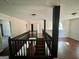 Upstairs hallway with dark wood railing and stairs at 1529 Evergreen Hollow Ln, Conyers, GA 30012