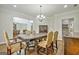 Elegant dining room featuring a large table, chandelier, and hardwood floors at 170 Castlewood Rd, Tyrone, GA 30290