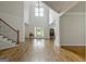 Bright and spacious entryway with hardwood floors and staircase at 170 Castlewood Rd, Tyrone, GA 30290