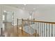 Upstairs hall with hardwood floors and elegant railing at 170 Castlewood Rd, Tyrone, GA 30290