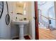 Powder room with pedestal sink, view of staircase with patterned tile at 1285 E Hwy 5, Carrollton, GA 30116