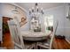 Dining room with rustic table, chandelier, and view into kitchen at 1285 E Hwy 5, Carrollton, GA 30116