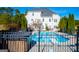 Large pool with diving board and hot tub, adjacent to a two-story house at 1285 E Hwy 5, Carrollton, GA 30116