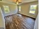 Bright bedroom with wood-look floors and multiple windows at 219 Decatur Rd, Mcdonough, GA 30253