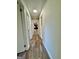 Long hallway with light walls and wood-look floors at 219 Decatur Rd, Mcdonough, GA 30253