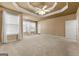 Large main bedroom with carpeted floors and tray ceiling, offering ample space at 340 Antebellum Way, Fayetteville, GA 30215