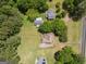 House nestled in a wooded area with a large yard and neighboring houses visible at 611 Bernhard Rd, Fayetteville, GA 30215
