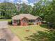 Ranch style brick house with driveway and large yard at 611 Bernhard Rd, Fayetteville, GA 30215