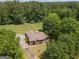 Brick ranch house with large backyard, driveway, and spacious green lawn at 611 Bernhard Rd, Fayetteville, GA 30215