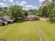 Large backyard with fenced perimeter and neighboring house visible at 611 Bernhard Rd, Fayetteville, GA 30215