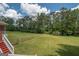Spacious backyard with a large grassy area and a tree line at 611 Bernhard Rd, Fayetteville, GA 30215