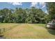 Large backyard with fenced-in area and mature trees at 611 Bernhard Rd, Fayetteville, GA 30215
