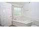 Relaxing bathroom with corner jacuzzi tub and window at 611 Bernhard Rd, Fayetteville, GA 30215