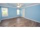 Bright bedroom with ceiling fan and wood-look floors at 611 Bernhard Rd, Fayetteville, GA 30215