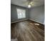Bright bedroom with wood-look floors and a window offering natural light at 611 Bernhard Rd, Fayetteville, GA 30215