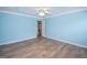 Spacious bedroom with light blue walls and wood-look floors at 611 Bernhard Rd, Fayetteville, GA 30215