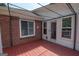 Red deck with brick wall, door, and pergola at 611 Bernhard Rd, Fayetteville, GA 30215