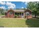 Brick ranch home with screened porch and landscaped yard at 611 Bernhard Rd, Fayetteville, GA 30215