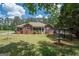 Brick ranch home with screened porch and landscaped yard at 611 Bernhard Rd, Fayetteville, GA 30215
