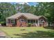 Brick ranch home with screened porch and landscaped yard at 611 Bernhard Rd, Fayetteville, GA 30215