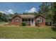 Brick house with a screened porch and well-maintained lawn at 611 Bernhard Rd, Fayetteville, GA 30215