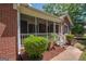 Brick house with a screened porch and landscaping at 611 Bernhard Rd, Fayetteville, GA 30215
