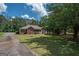 Brick house with driveway, landscaping, and screened porch at 611 Bernhard Rd, Fayetteville, GA 30215