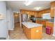 Island kitchen with oak cabinets, granite countertops, and stainless steel appliances at 611 Bernhard Rd, Fayetteville, GA 30215
