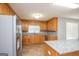 Kitchen features an island, oak cabinets, granite countertops, and stainless steel appliances at 611 Bernhard Rd, Fayetteville, GA 30215
