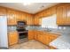 Spacious kitchen with oak cabinets, granite countertops, and stainless steel appliances at 611 Bernhard Rd, Fayetteville, GA 30215