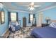 Main bedroom with blue walls, ceiling fan, and ample space at 611 Bernhard Rd, Fayetteville, GA 30215