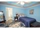 Main bedroom with blue walls, ceiling fan, and ensuite bath at 611 Bernhard Rd, Fayetteville, GA 30215