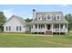 Two-story home with wraparound porch and attached garage at 2110 Mcgarity Rd, Mcdonough, GA 30252