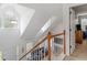 Upstairs hallway overlooking the living room with a wooden railing and skylights at 2110 Mcgarity Rd, Mcdonough, GA 30252