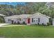 Charming ranch home with gray siding, red door, and well-manicured lawn at 2658 Rollingwood Se Ln, Atlanta, GA 30316