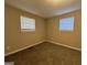 Well-lit bedroom with neutral walls and carpet flooring at 4906 Springbrook Dr, Douglasville, GA 30135