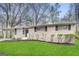 Ranch style home with brick facade, and a spacious lawn at 4906 Springbrook Dr, Douglasville, GA 30135