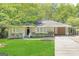 Newly renovated ranch home with carport and well-manicured lawn at 1737 Mckenzie Dr, Decatur, GA 30032