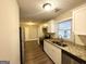 Modern kitchen with white cabinets, granite counters, and stainless steel appliances at 1737 Mckenzie Dr, Decatur, GA 30032