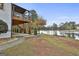 Landscaped backyard with a patio and access to a lake at 12021 Scottish Ct, Fayetteville, GA 30215