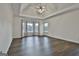 Main bedroom with tray ceiling, hardwood floors, and large windows at 12021 Scottish Ct, Fayetteville, GA 30215