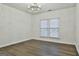 Bright bedroom with hardwood floors and window blinds at 12021 Scottish Ct, Fayetteville, GA 30215
