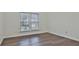Well-lit bedroom featuring hardwood floors and large windows at 12021 Scottish Ct, Fayetteville, GA 30215